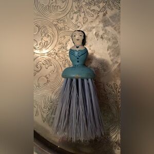 Vintage clothes/hat brush. Doll is wooden